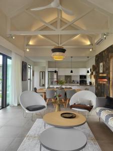 a living room with a couch and chairs and a table at Villa de Luxe à Grand Baie avec piscine V12 in Grand Baie