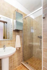 a bathroom with a sink and a glass shower at Casita Rural CANTONAL in Valencia