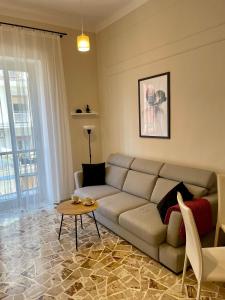 a living room with a couch and a table at Two Balcony Central Bari in Bari