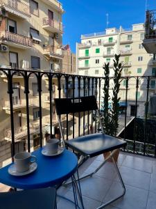 a blue table and a chair on a balcony at Two Balcony Central Bari in Bari