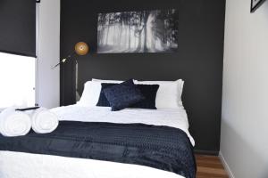a black and white bedroom with a large bed at Ballantines on the Rocks in Steppes