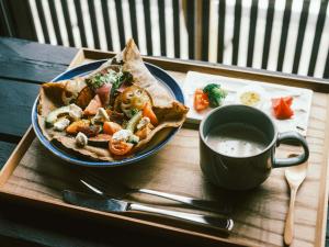 a plate of food and a cup of coffee on a tray at SATOYAMA STAY Nino-Machi in Furukawachō