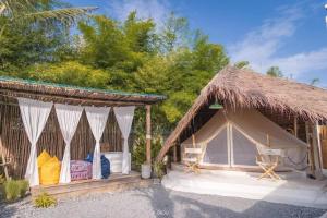 a luxury tent with two chairs and a bed at The Pattaya Glamper in North Pattaya