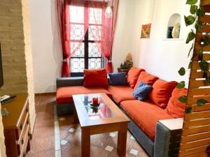 een woonkamer met een bank en een tafel bij Buhardilla de Wallada Córdoba in Córdoba