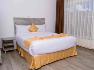 Ένα ή περισσότερα κρεβάτια σε δωμάτιο στο KISIMANI ECO RESORT & SPA LTD