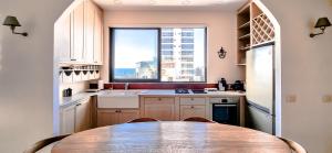 a kitchen with a table and a large window at BnBIsrael apartments - Daniel Royal in Tel Aviv