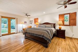 a bedroom with a bed and a ceiling fan at Marshall Street Music Retreat in Boise