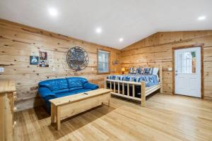a bedroom with wooden walls and a blue couch and a bed at Marshall Street Music Retreat in Boise