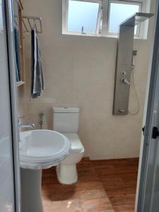 a bathroom with a toilet and a sink at The Perfect Getaway in Grand Baie