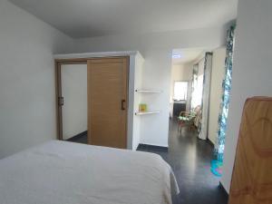 a bedroom with a bed and a door to a hallway at The Perfect Getaway in Grand Baie