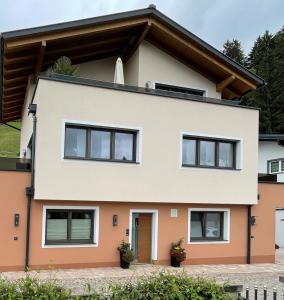 a house with black windows at Appartement Melanie in Wagrain