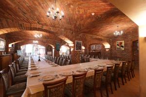 a long dining room with a long table and chairs at Pałac Biedrusko in Poznań