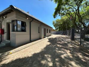 uma casa com uma entrada de tijolos ao lado de um edifício em Ecomotel Louis Botha em Joanesburgo