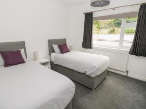 a hotel room with two beds and a window at Westwinds in Tenby