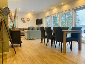 a living room with a table and chairs and a couch at Maison de vacances privative à louer in Aywaille