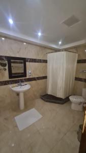 a bathroom with a sink and a toilet at Uni sharm aqua park in Sharm El Sheikh