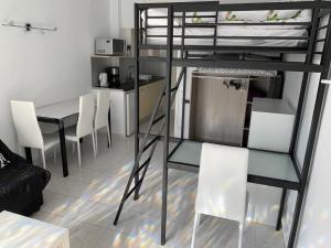 a loft bed with a table and chairs in a room at Agi Estrella de Mar in Roses