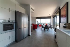 a kitchen with stainless steel appliances and a dining room at Bautiful Penthouse 4Bed with Jacuzzi sea view in Tel Aviv