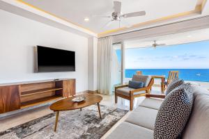 a living room with a television and a couch and a table at Blue Horizon 801 in Puerto Vallarta