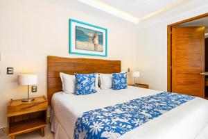 a bedroom with a bed with blue and white sheets at Blue Horizon 801 in Puerto Vallarta +27 photos