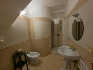ein Badezimmer mit einem Waschbecken, einem WC und einem Spiegel in der Unterkunft B&B Liberty in Palermo