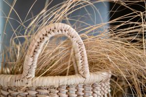 a wicker basket with tall grass in the background at Mount High Luxury Stables in Lydenburg