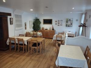 a dining room with wooden tables and chairs at Hôtel restaurant Le Marronnier in Tramayes