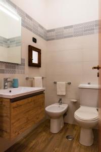a bathroom with a toilet and a sink at Appartamenti Vittoria in Syracuse