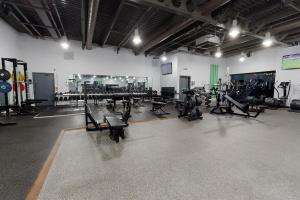 a gym with rows of exercise equipment in a room at Village Hotel Leeds South in Leeds