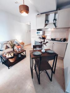 a living room with a table and a kitchen at APARTAMENTO FRENTE AL MAR CON PRECIOSAS VISTAS in Mazagón