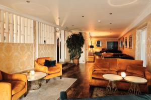 a living room with couches and tables at Hotel De Normandie in Saint Helier Jersey