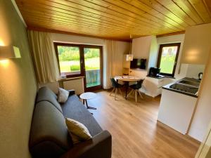 a living room with a couch and a table at AlpenApart Montafon - Haus Engstler in Schruns-Tschagguns