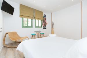 a bedroom with a bed and a table and chairs at Cathedral Apartments in Barcelona