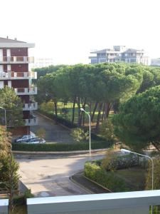 a view of a parking lot with trees and a building at Appartamenti Primula Uno in Silvi Marina