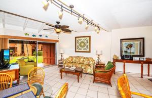 a living room with a couch and chairs at Kuleana Resort 209 in Kahana