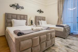 a bedroom with two beds and a large window at Primestay - Meera Tower 2BR in Habtoor City in Dubai
