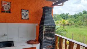 a kitchen with a brick oven on a balcony at Casa temporada jaguaripe bahia toca do guaiamum in Jaguaripe