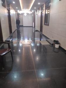 a man standing in a hallway of a building at Hotel Uday Raj By WB Inn in Agra