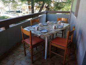 a table on a balcony with two chairs and a table with cups at Appartamenti Primula Uno in Silvi Marina