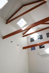 a room with skylights and wooden beams at Bendigo Townhouse - Walk to the CBD in Bendigo