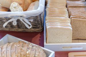 a bunch of different types of bread in baskets at Hotel La Milagrosa in Alicante