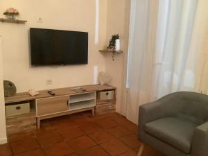 a living room with a flat screen tv on the wall at VILLA ALIZÉE APPARTEMENT 3 in Sainte-Rose