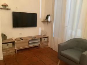 a living room with a flat screen tv on the wall at VILLA ALIZÉE Logement 3 in Sainte-Rose