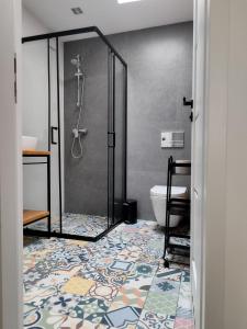 トルンにあるApartament KO-Piernika w samym sercu Torunia :)のシャワーとタイル張りの床を備えたバスルーム