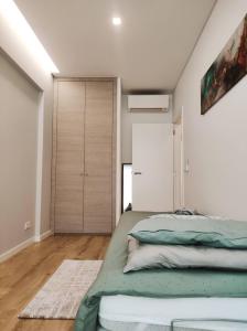 a bedroom with a bed and a closet at Elite House Estoril in Estoril