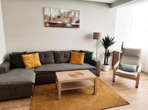 a living room with a couch and a table at Elite House Estoril in Estoril