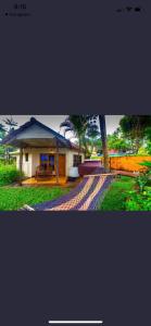 a picture of a house with a tree in front of it at The village in Varkala