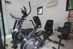 a gym with two exercise bikes in a room at Hotel Montha in Chiang Mai