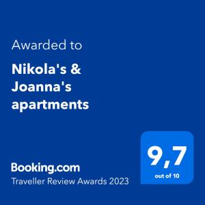 a blue text box with the words awarded to nikolaos and japan at Nikola's & Joanna's apartments in Argostoli