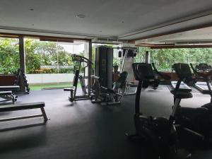 a gym with several treadmills and elliptical machines at Andaman sea view private in Patong Beach